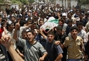 Palestinian mourners chant slogans as they carry the body of Hamas militant Ahmad Al Abdullah, who was killed in an Israeli army raid, during his funeral in Khan Younis, in the southern Gaza Strip, Wednesday, June 20, 2007. Israel fired missiles and sent tanks on a foray into Gaza on Wednesday, killing four Palestinians in the deadliest military action since Hamas militants took control of the coastal strip. (AP Photo/Eyad Albaba)
