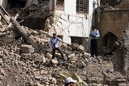 Police on guard stand amid the rubble of the damaged Khulani  mosque in central Baghdad, Iraq, Wednesday, June 20, 2007. The death toll from Tuesday's suicide truck bombing at the major Shiite mosque  has risen to 87, the Interior Ministry reported Wednesday. The ministry said 214 others were injured in the blast, which struck just as worshippers were leaving a midday prayer service . (AP Photo/Hadi Mizban)